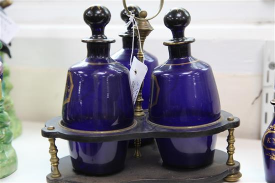 A Regency gilt decorated blue glass three bottle decanter stand, height 24.5cm